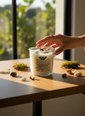 Evolve Botanica Go Touch Grass Rocks Candle — wood wick soy candle topped with Moss Agate and Ruby Zoisite, scented with petrichor, moss, cedarwood, sandalwood and mushroom