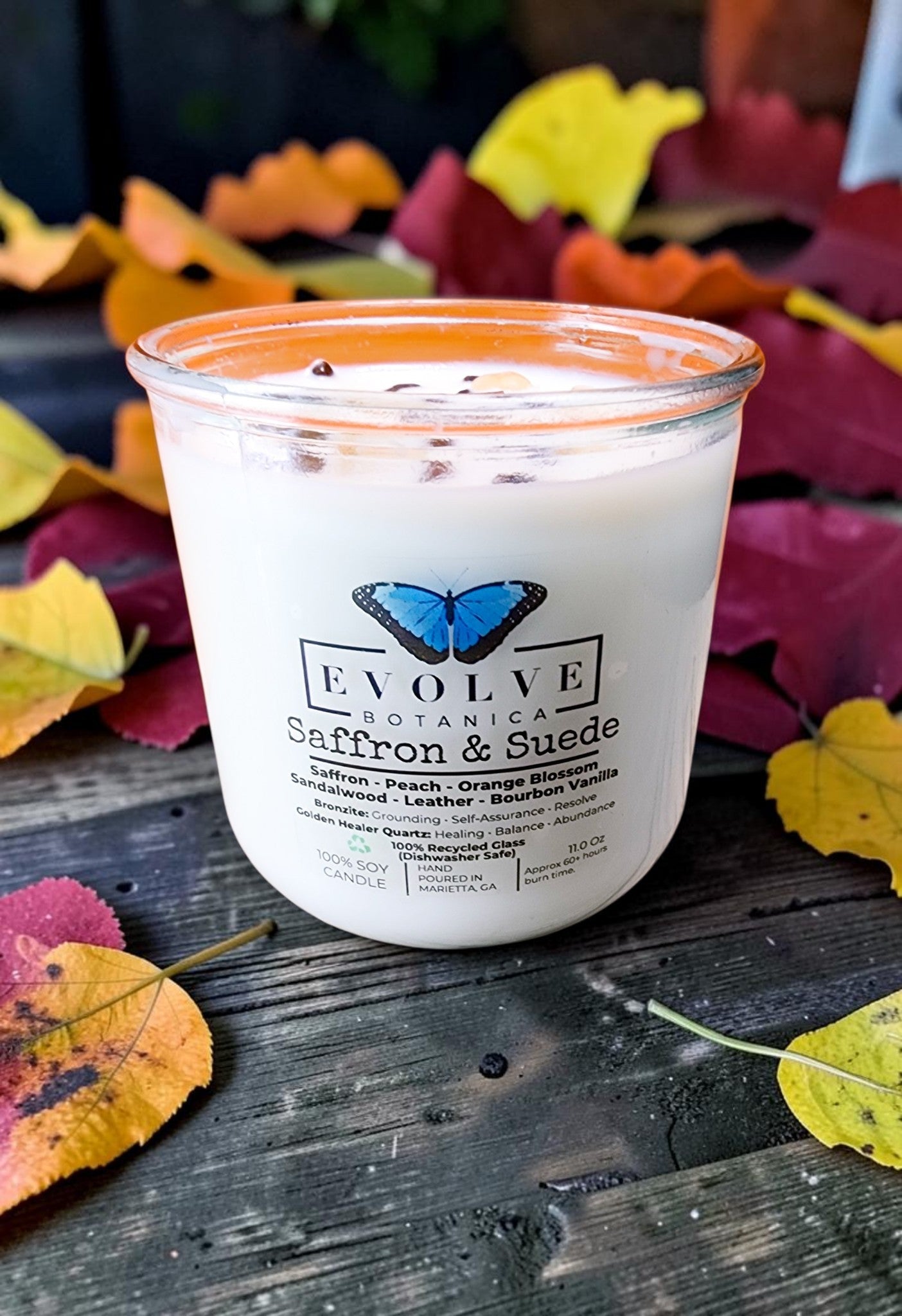 Saffron and Suede Rocks Candle - saffron peach sandalwood leather soy candle with Bronzite and Golden Healer Quartz on autumn leaves