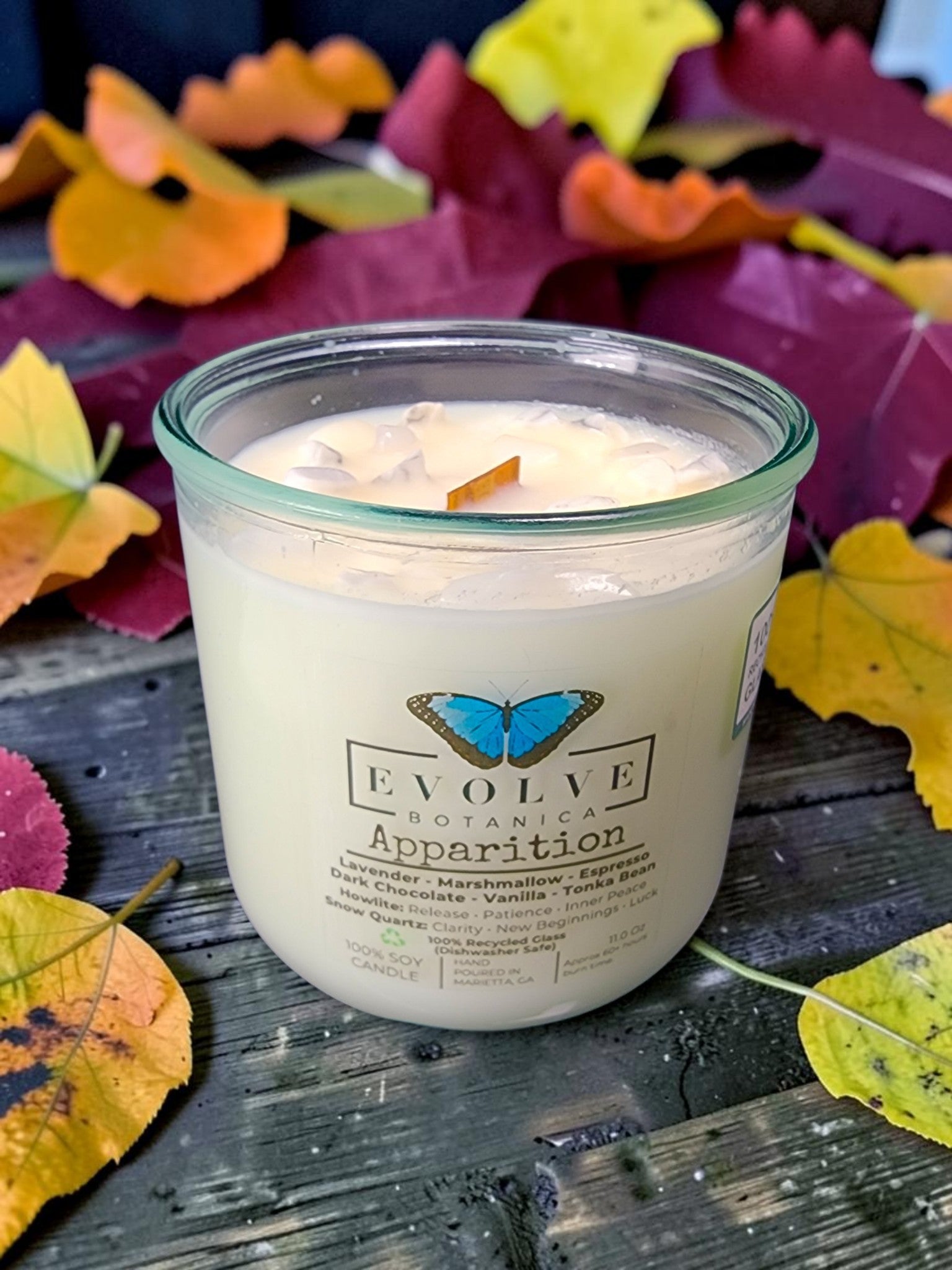Apparition gemstone candle front label on autumn leaves
