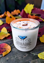 Saffron and Suede candle with Bronzite and Golden Healer Quartz on autumn leaves