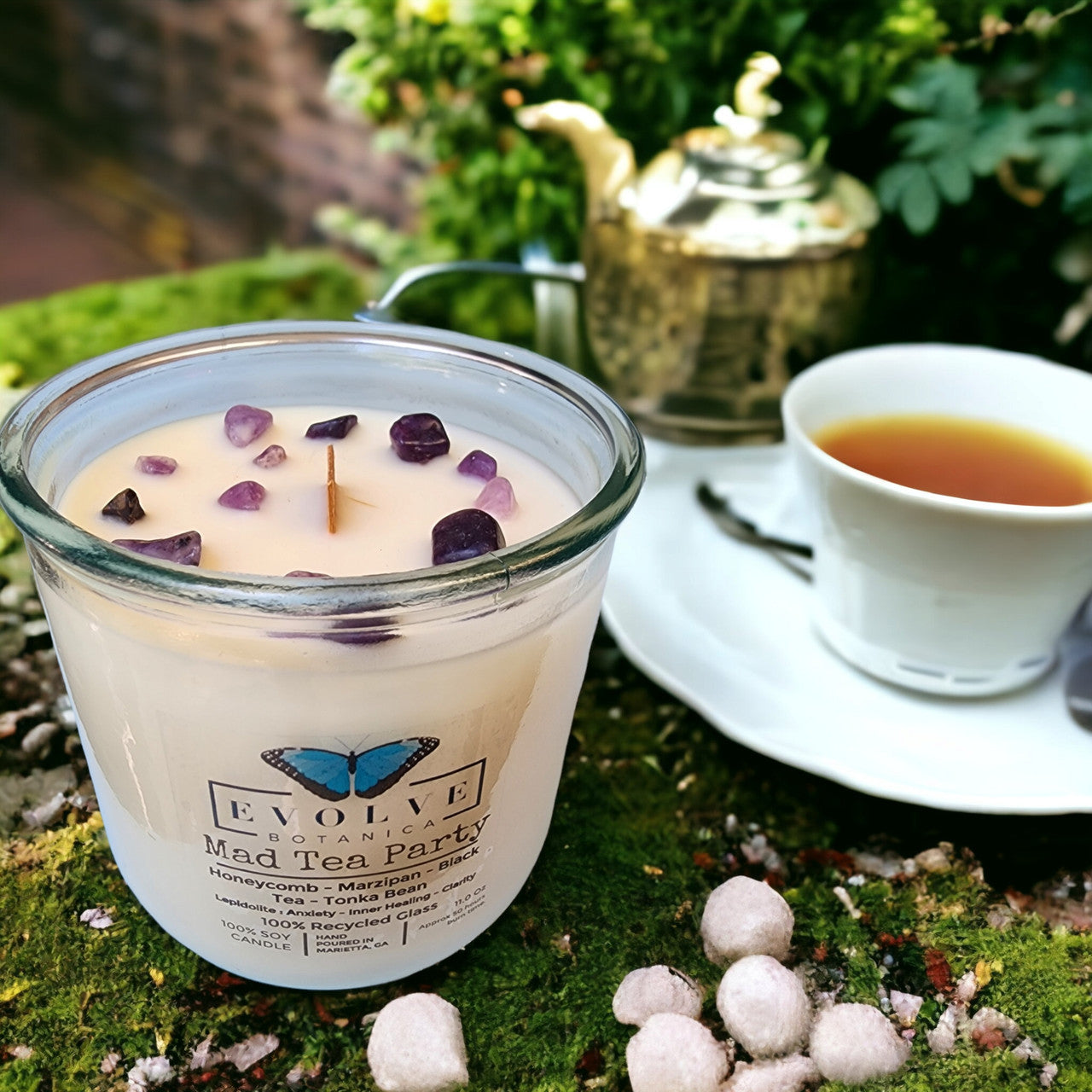 Close-up of Lepidolite crystal in Mad Tea Party candle — calming peace stone