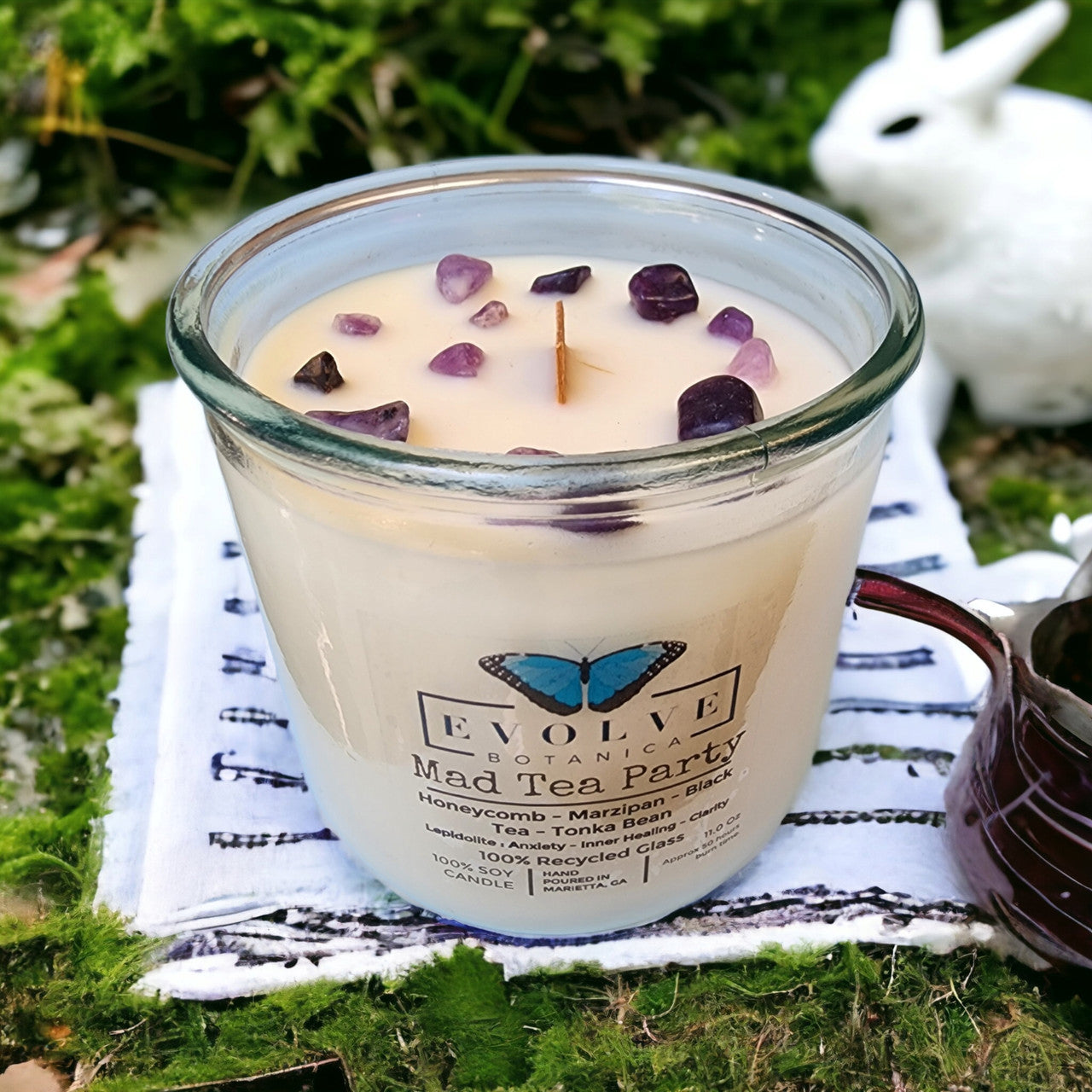 Mad Tea Party wood wick soy candle lit — whimsical Alice in Wonderland atmosphere