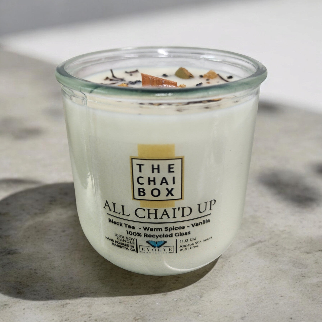 Evolve Botanica All Chai'd Up Rocks Candle — wood wick soy candle topped with loose All Chai'd Up chai (Chai Box × Evolve Botanica collab)