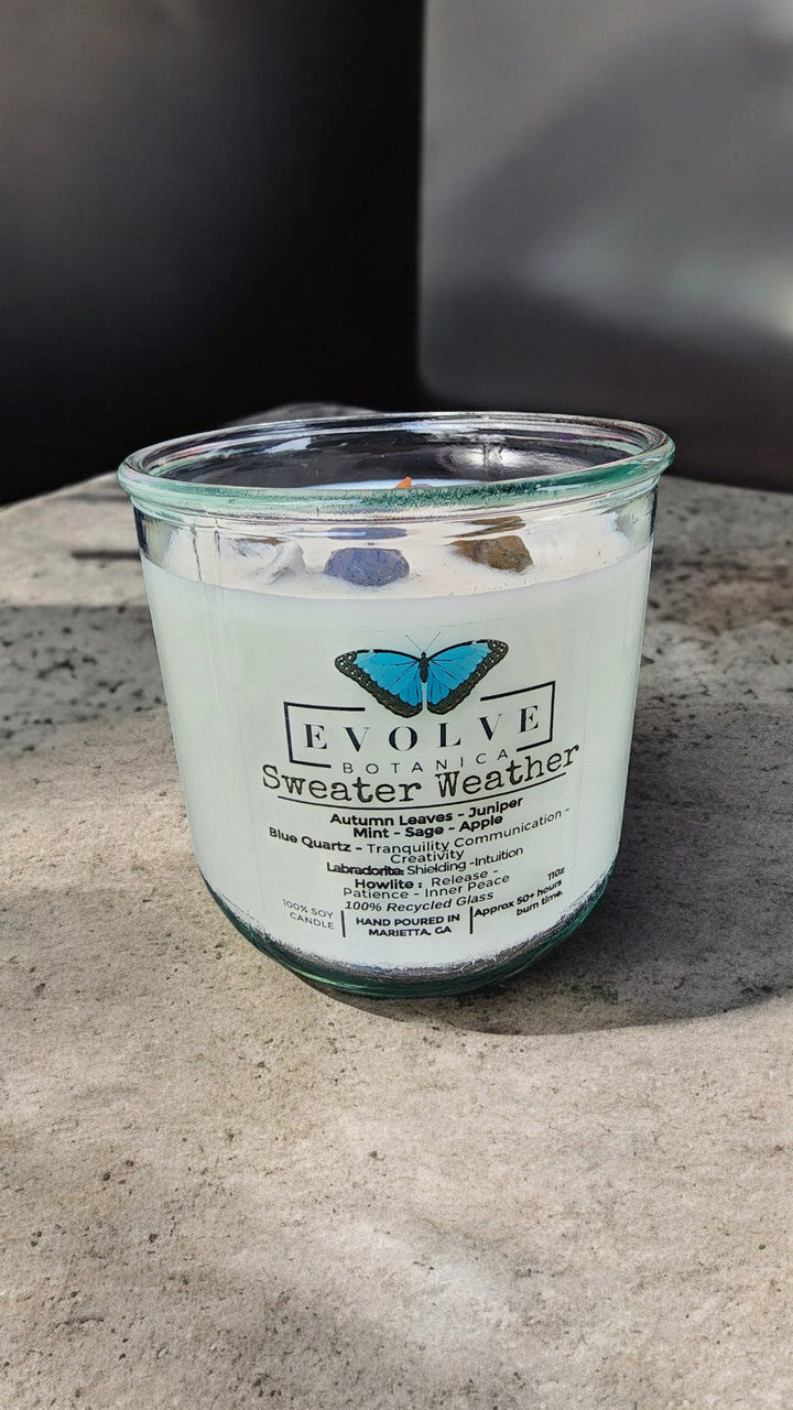 Sweater Weather wood wick soy candle lit — cozy autumn cabin atmosphere