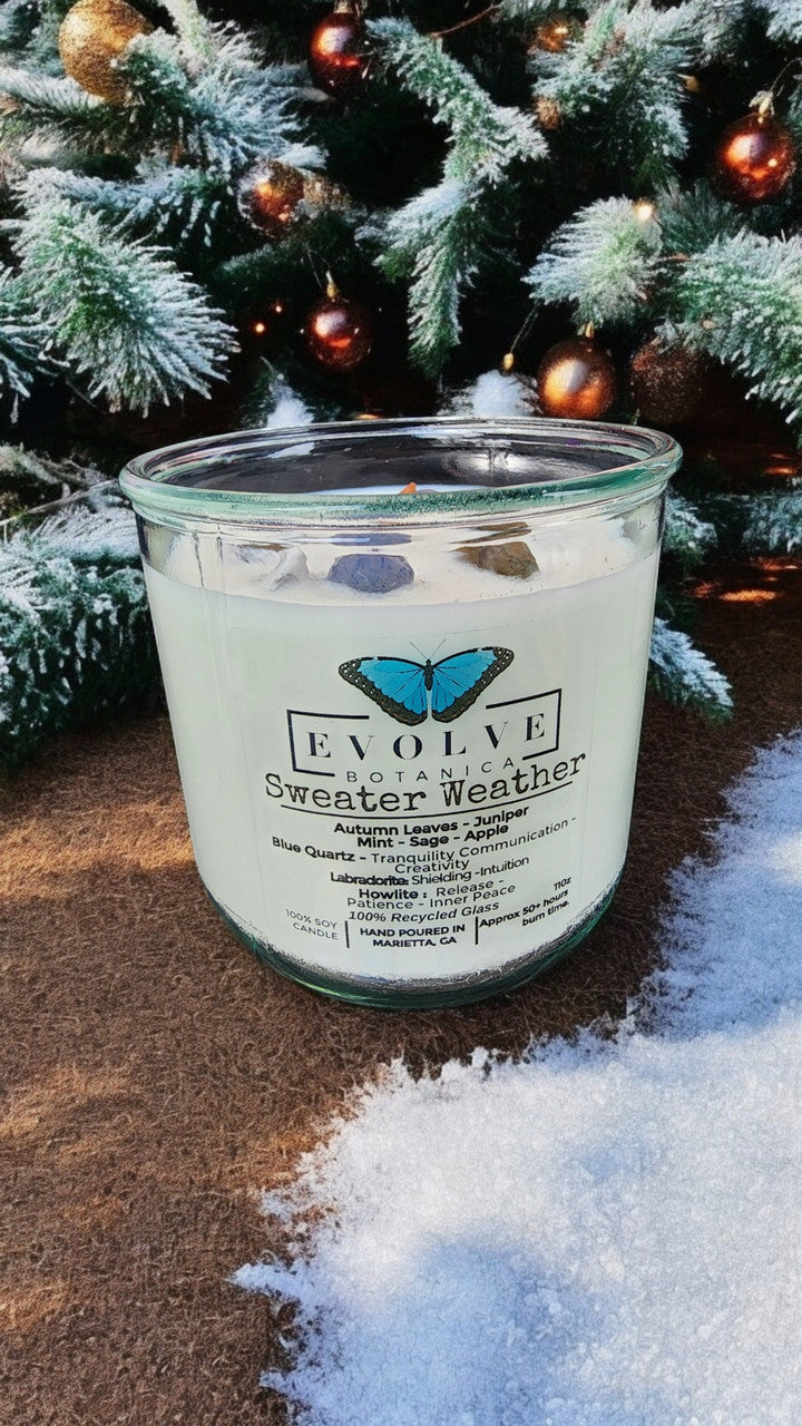 Sweater Weather Rocks candle styled with knit sweaters — autumn cozy decor