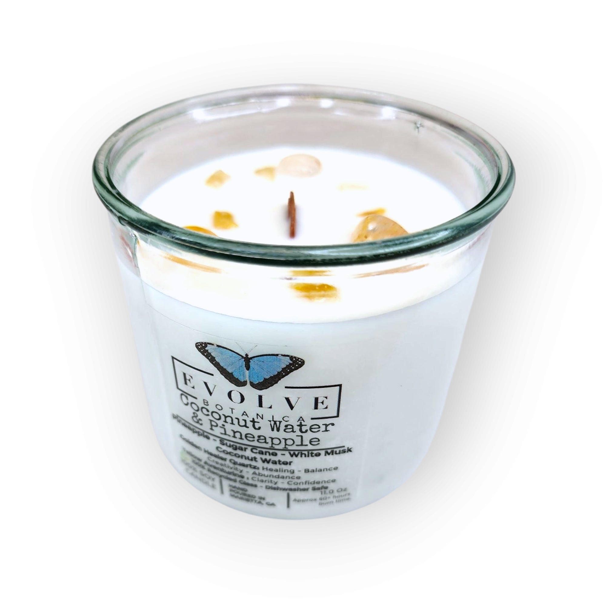 Evolve Botanica Coconut & Pineapple Rocks Candle — wood wick soy candle topped with Golden Healer Quartz and Yellow Aventurine, scented with pineapple, sugar cane and white musk