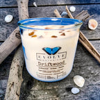 Driftwood wood wick soy candle lit — beachy amber and ozone atmosphere