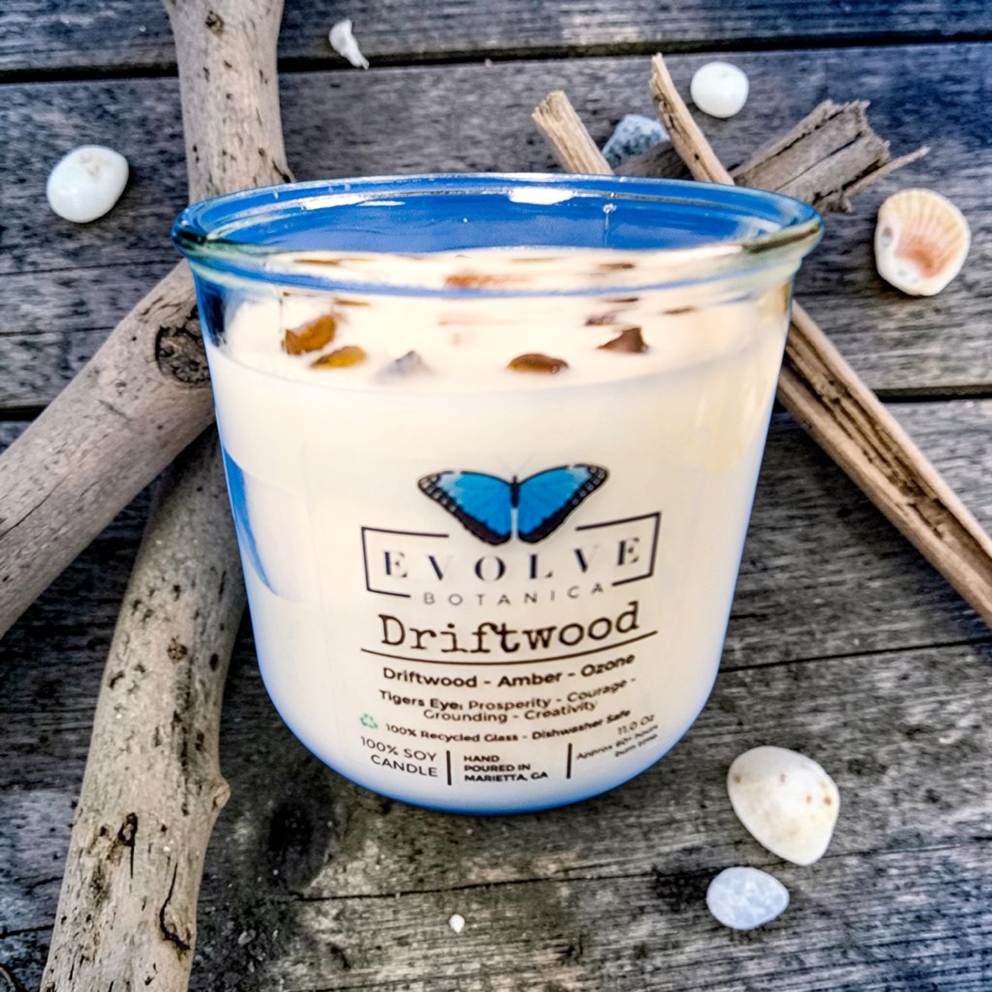 Driftwood wood wick soy candle lit — beachy amber and ozone atmosphere
