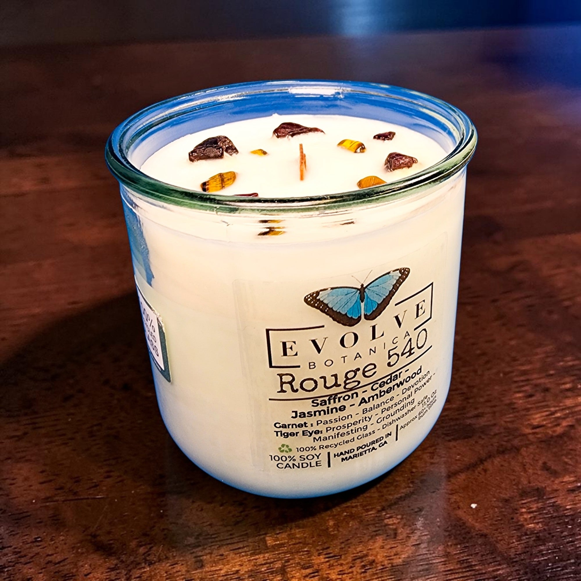 Evolve Botanica Rouge 540 Rocks Candle — wood wick soy candle topped with Garnet and Tiger Eye, scented with saffron, jasmine, cedar and amberwood