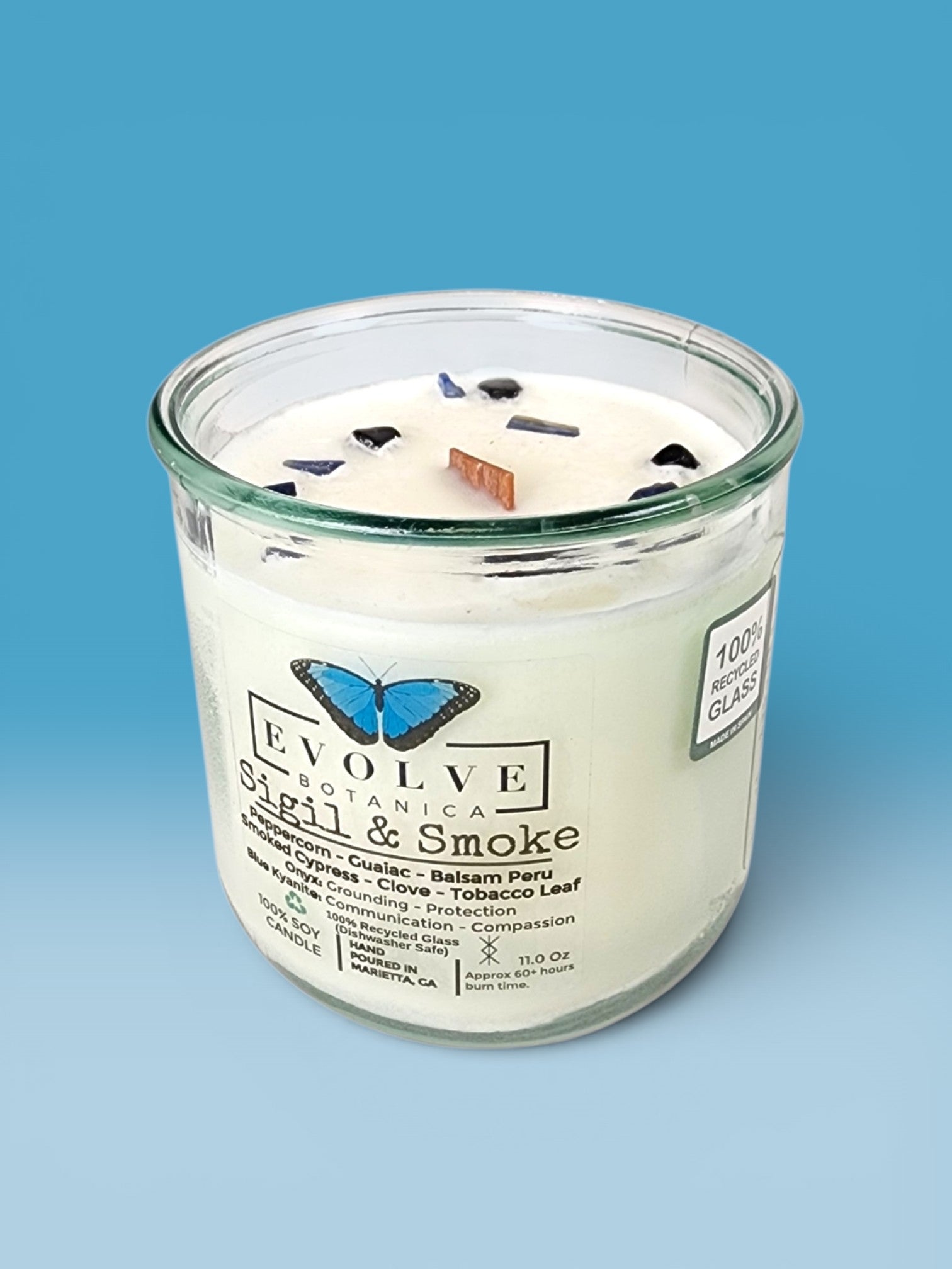 Sigil & Smoke Rocks candle on blue — smoky tobacco and balsam wood wick soy candle, smoked cypress and clove, Evolve Botanica