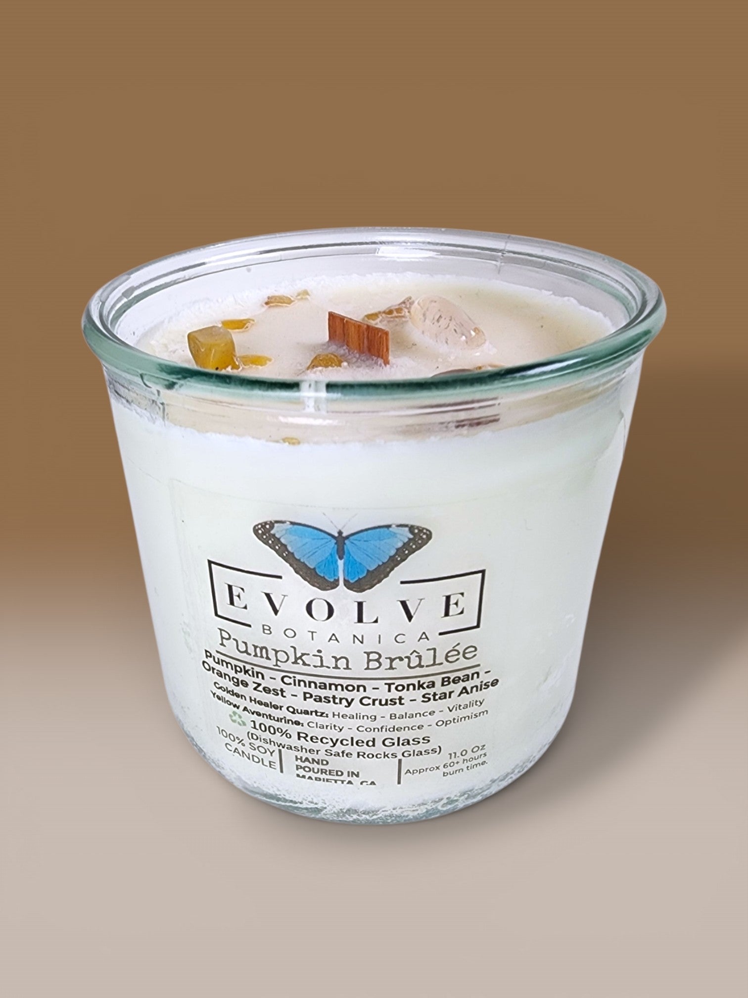 Evolve Botanica Pumpkin Brulee Rocks Candle — wood wick soy candle topped with Golden Healer Quartz and Yellow Aventurine, scented with pumpkin, cinnamon, tonka bean, orange zest, pastry crust and star anise