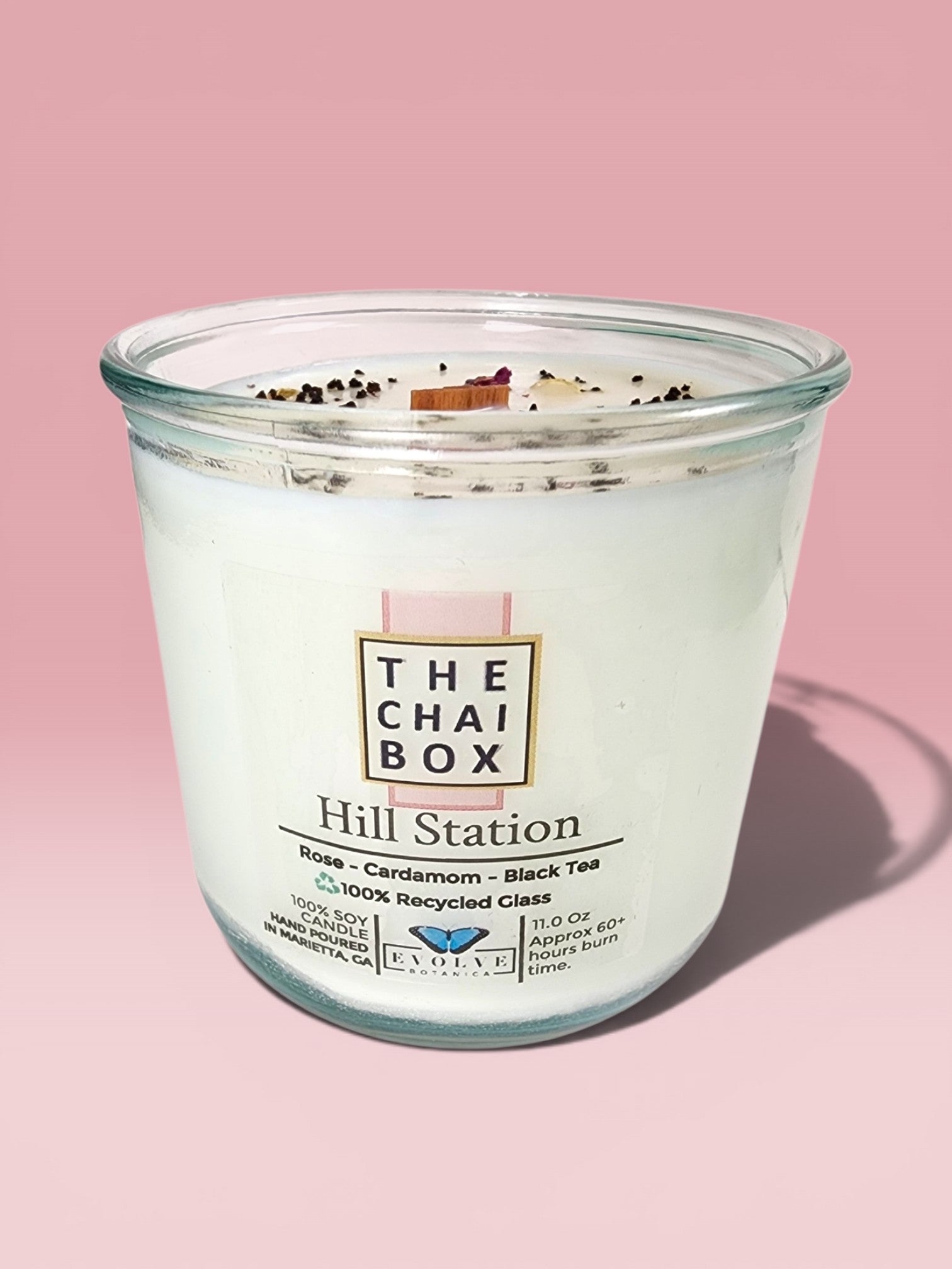 Evolve Botanica Hill Station Rocks Candle — wood wick soy candle topped with loose Hill Station chai (Chai Box × Evolve Botanica collab), scented with rose, cardamom and black tea