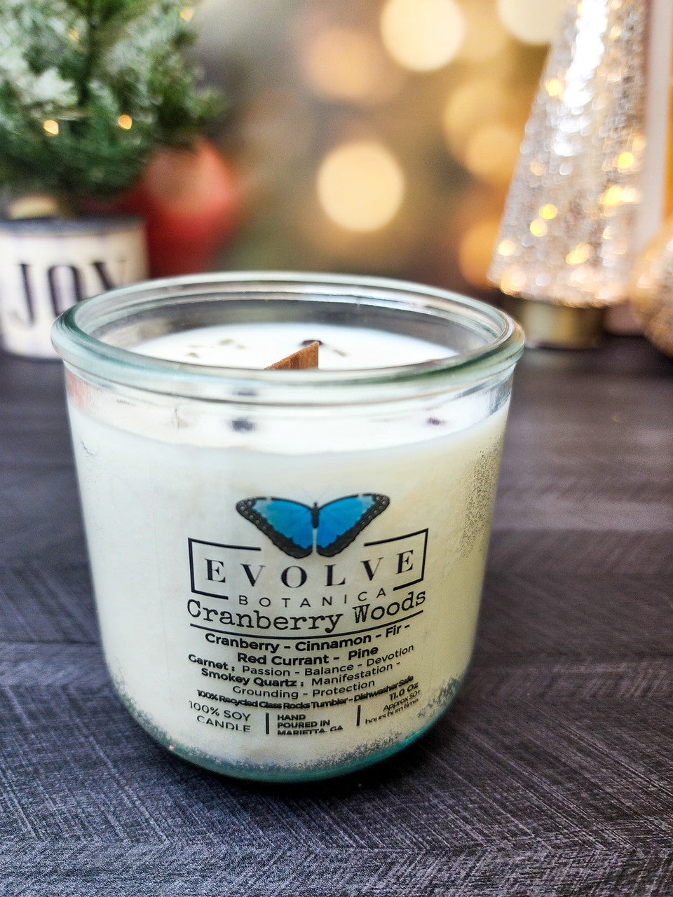 Cranberry Woods wood wick soy candle lit — cozy holiday cabin atmosphere