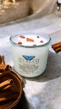 Praline Cinnamon Bun wood wick soy candle lit — cozy bakery atmosphere