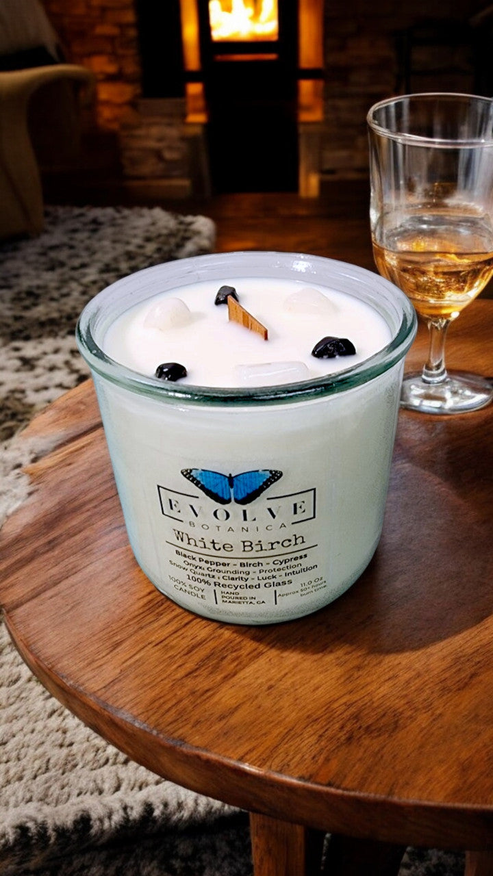 White Birch Rocks candle styled with birch wood — winter cabin decor