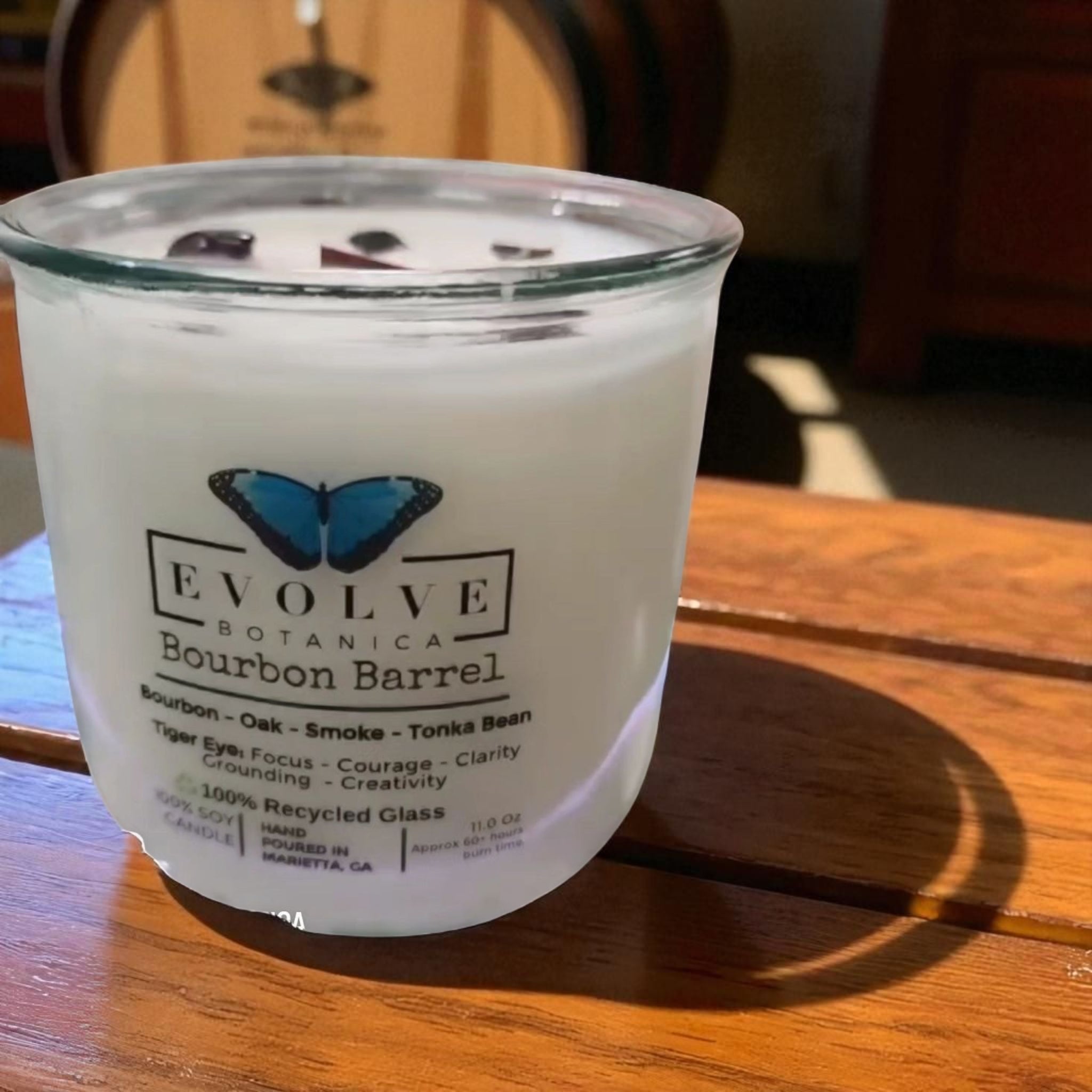 Evolve Botanica Bourbon Barrel Rocks Candle — wood wick soy candle topped with Tiger Eye, scented with bourbon, oak, smoke and tonka bean