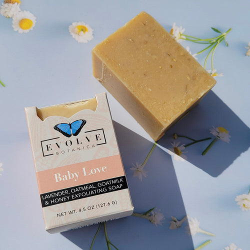 Baby Love goat milk soap styled with lavender sprigs and oats on linen — gentle sensitive skin care