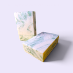 Two Silver Spruce handmade soap bars on a plain light background showing the green and cream swirl pattern
